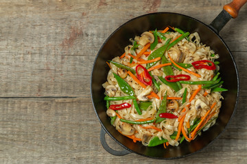 Chow Mein egg noodles with vegetables and mushrooms. The view from the top. Copy-space