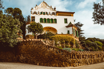House with a sundial in the Parc Guell. Park Guell was designed by Antoni Gaud .