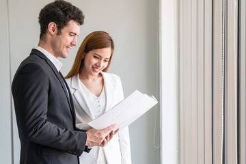 Businessman executive is in meeting discussion with businesswoman or client in modern workplace...