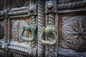 Closeup of old wooden door with vintage handle. Selective focus