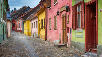 Fototapeta na wymiar Cityscape of colorful street in old town Sighisoara, Romania