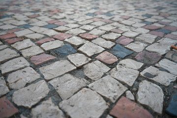 Perspective view floating over cobblestone tiles in the cloudy day