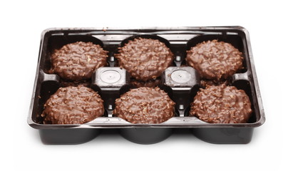 Cocoa cookies, biscuits with coconut in packaging isolated on white background