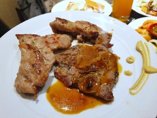 Top view of grilled pork steak with sauce on white plate, Ready to eat, Selective focus 