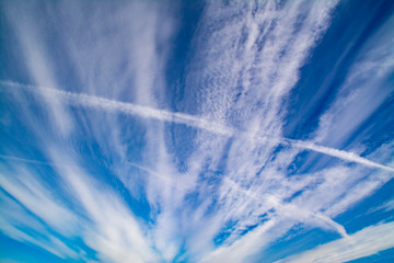 White clouds stretching out into perspective in blue sky