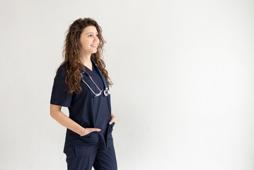 Medical concept of young beautiful female doctor with phonendoscope. Woman hospital worker, studio, white background with copy space