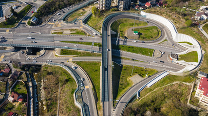 Aerial photography. Exit from the underground tunnel. Bypass road. Transport ring. Multi-level road junction. Alternate of Kurortny Avenue, Sochi. Top view on a Sunny day.