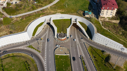 Aerial photography. Exit from the underground tunnel. Bypass road. Transport ring. Multi-level road...
