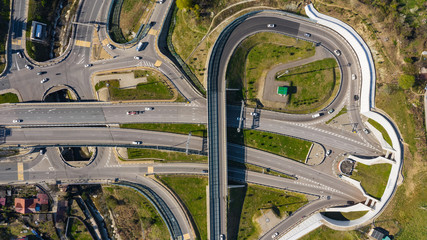 Aerial photography. Exit from the underground tunnel. Bypass road. Transport ring. Multi-level road junction. Alternate of Kurortny Avenue, Sochi. Top view on a Sunny day.