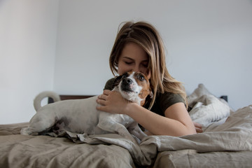 Woman with dog in a bed