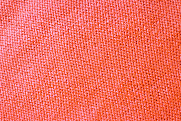 Knitted surface trend coral color close-up, fashionable background