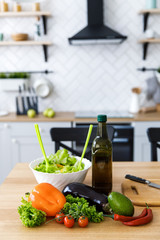 Fresh and juicy vegetables are on the table in the kitchen. Preparation of healthy food