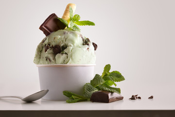 Composition of mint choco ice cream ball in paper cup