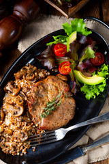 Pork steak with mushrooms and buckwheat groats and mango salad
