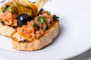 Delicious Italian antipasti bruschetta on white background. Macro. Copy space.