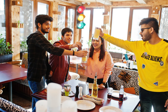 Group Of Asian Friends Sitting Cafe. Happy Indian People Having Fun Together And Cheers By Glasses Of Juice.