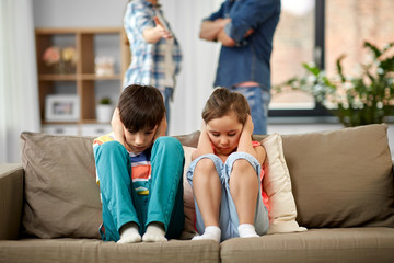 family problem, conflict and people concept - sad children closing ears while their parents...