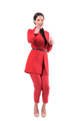 Excited successful business woman showing thumbs up and winking at camera. Full body isolated on...