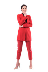 Cheerful excited business woman in red suit laughing and looking up. Full body isolated on white...