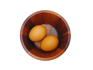 Two organic fresh egg in wooden bowl  isolated on white background