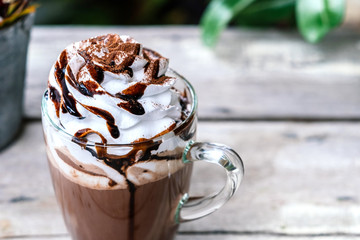 Hot chocolate cocoa in glass mug with whipped cream