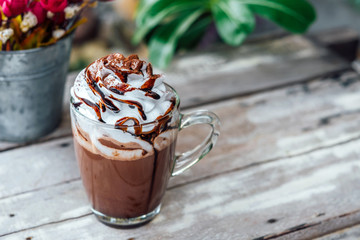 Hot chocolate cocoa in glass mug with whipped cream