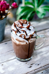 Hot chocolate cocoa in glass mug with whipped cream