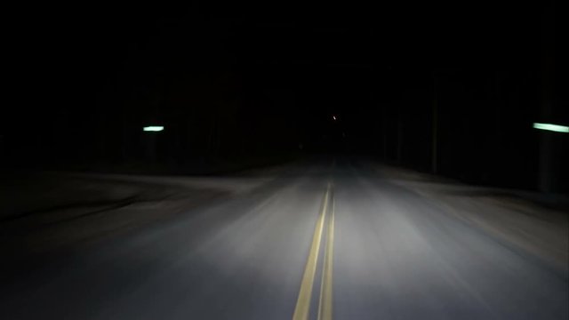 Driving twisting turning rural highway in pitch black night timelapseRunning from the law driving down a dark country highway, twisting and turning left and right. The night is dark and the road is lo