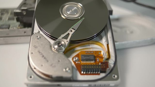 Disassembled hdd reading head. Hard disk drive initialization.