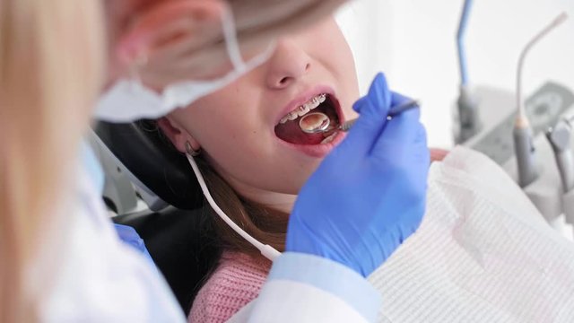 Part of dentist using dental mirror during check up