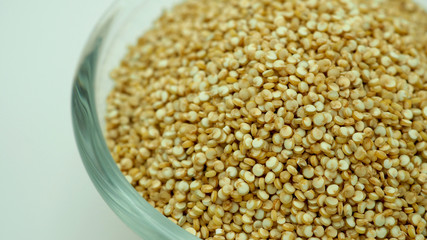 Fototapeta premium Natural White Quinoa in bow on white background.