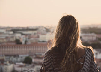 portrait of young woman in front of city