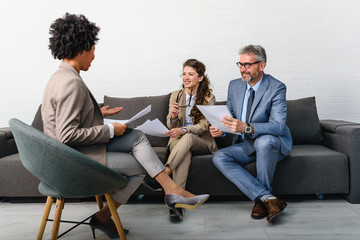 Business people having informal meeting in office. Diverse team discussing work.