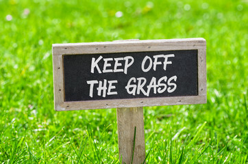Sign on a green lawn - Keep off the grass