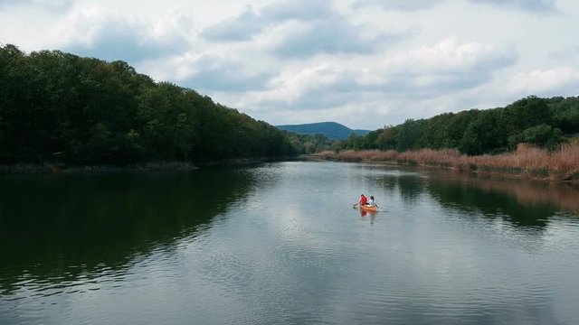 Canoeist paddling canoe on lake