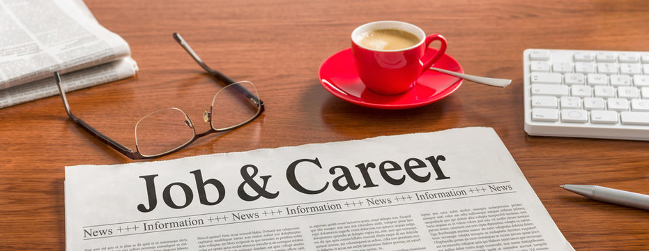 A newspaper on a wooden desk - Job and Career