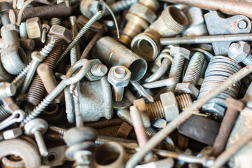 Close-up old used spare part, rust bolts and knots many sizes