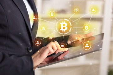 Business woman using tablet with cryptocurrency bitcoin link network and online concept
