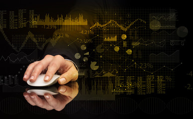 Hand using wireless mouse with financial concept on dark background

