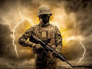 Armed soldier standing in rainy obscure weather
