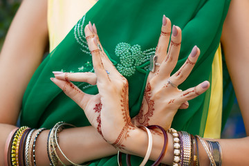 Beautiful woman in traditional Muslim Indian wedding green sari dress costume with henna tattoo...