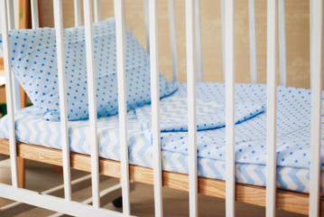 Fototapeta na wymiar Vintage white wooden decorated empty baby cot