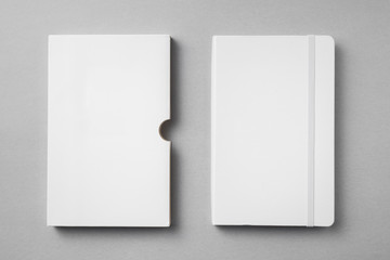 white notebook with case on grey for mock up - obrazy, fototapety, plakaty