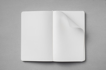 white notebook with turn page on grey background