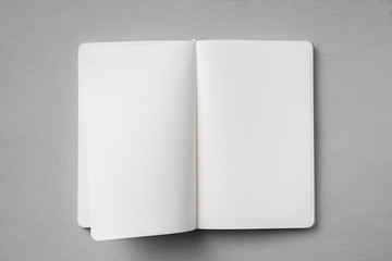 white notebook with turn page on grey background