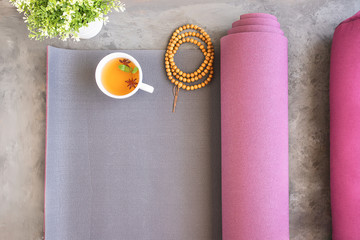 Open yoga mat and bolster for practice, wooden mala beads for metitation , Ayurveda tea for relax