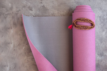 Yoga mat and classic mala beads, essential things for yoga practice y meditation.Copy space