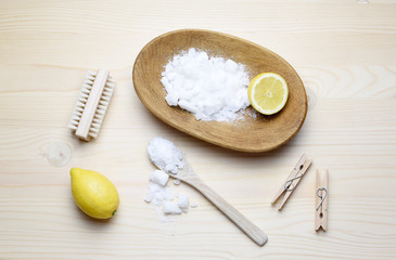Eco friendly natural cleaners, washing soda, lemon, crystalic salt on a wooden background. Europe, Czech republic,