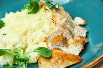 White rice with chicken breast. Rizotto. Gray light textured background. Beautiful serving of dishes. 
