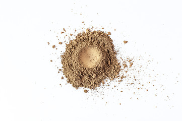 Natural brown colored pigment. Loose cosmetic powder. Matt eyeshadow pigment isolated on a white...